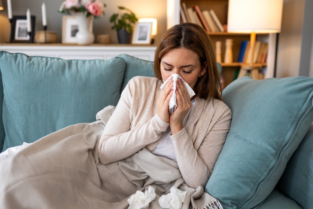 Sick,Woman,Blowing,Her,Nose,With,A,Tissue,On,A